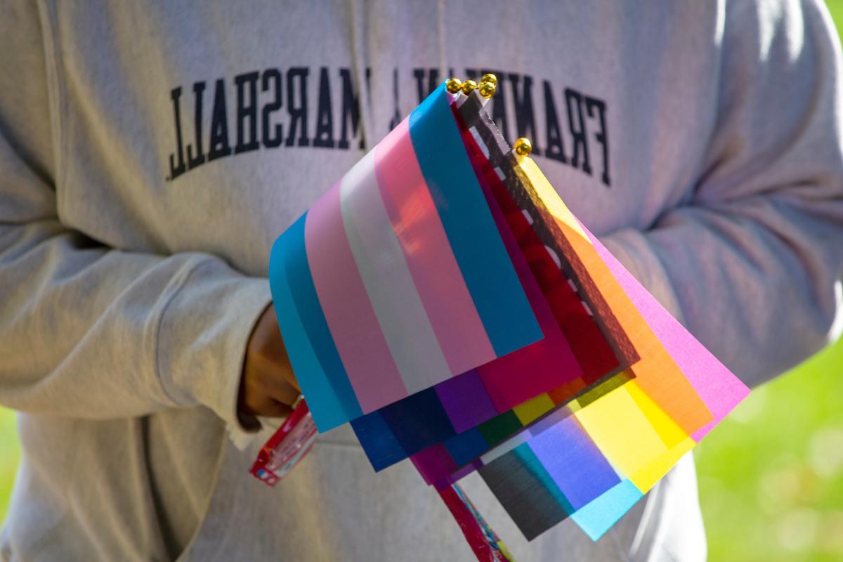 F&M student holding LGBTQ+ flags